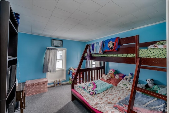 carpeted bedroom with ornamental molding