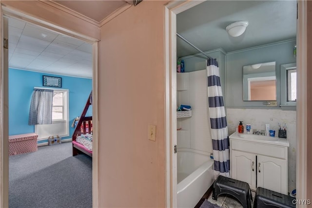 bathroom featuring vanity, shower / bath combo with shower curtain, and crown molding