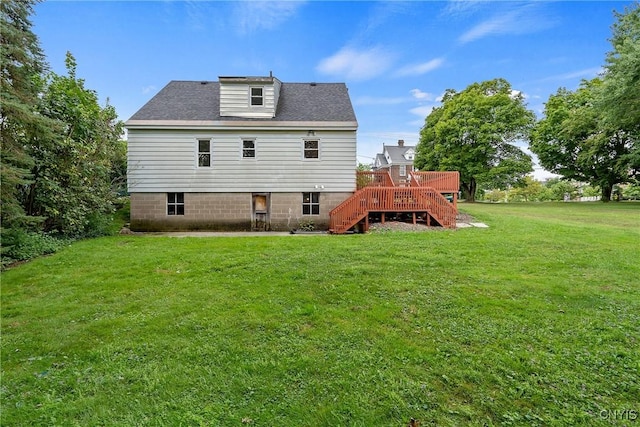 back of house with a yard and a deck