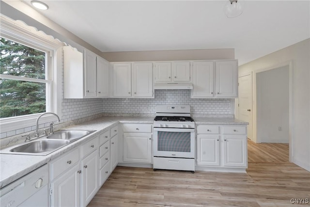 kitchen featuring white cabinets, white appliances, sink, and light hardwood / wood-style flooring