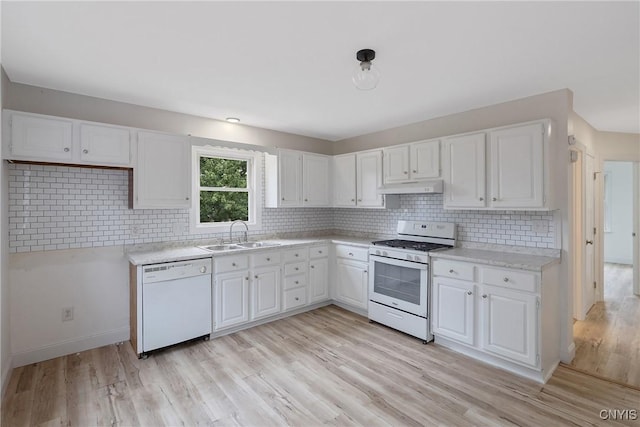 kitchen with sink, white cabinets, white appliances, and light hardwood / wood-style flooring