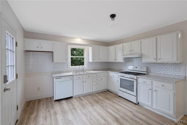 kitchen featuring backsplash, white appliances, sink, white cabinets, and light hardwood / wood-style floors