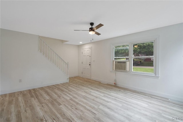 unfurnished living room featuring ceiling fan and light wood-type flooring