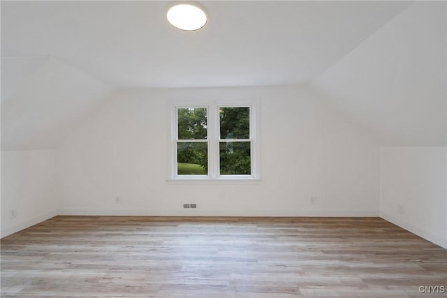 bonus room with light hardwood / wood-style flooring and lofted ceiling