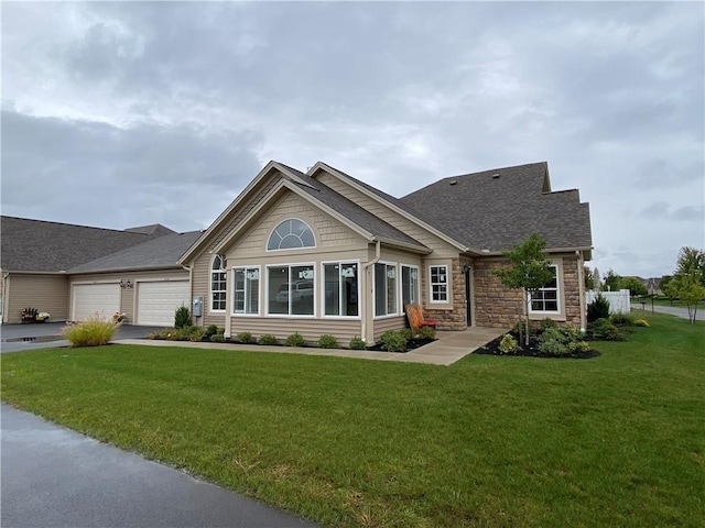 craftsman-style home with a front lawn and a garage