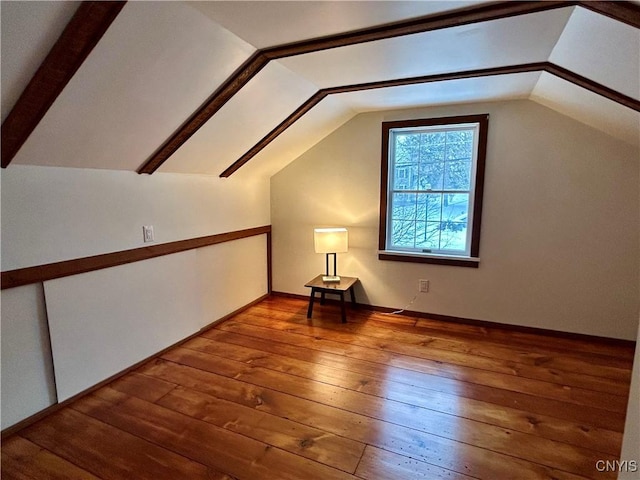 bonus room featuring wood-type flooring and vaulted ceiling