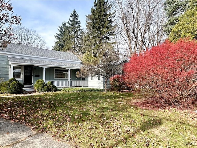 exterior space with a front yard and a porch