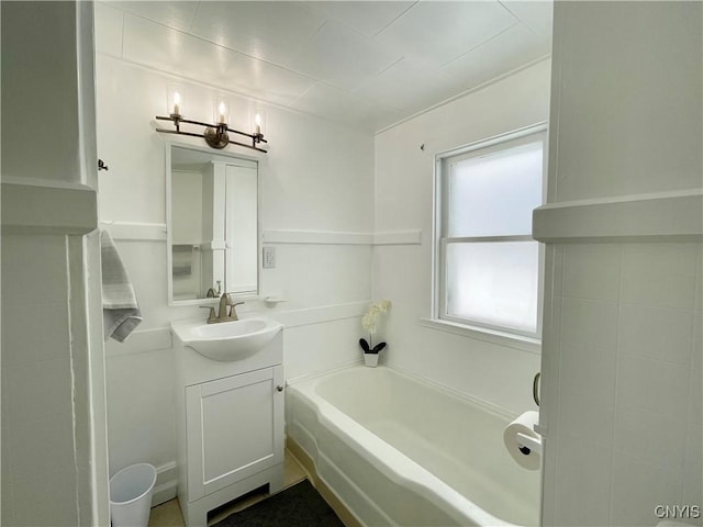 bathroom featuring vanity and a tub