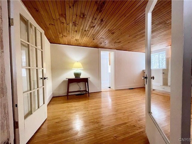 bonus room with french doors, light hardwood / wood-style flooring, and wooden ceiling