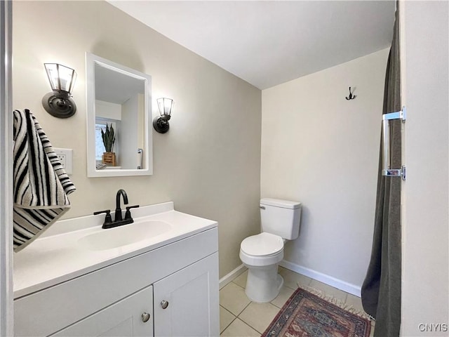 bathroom featuring toilet, vanity, and tile patterned floors