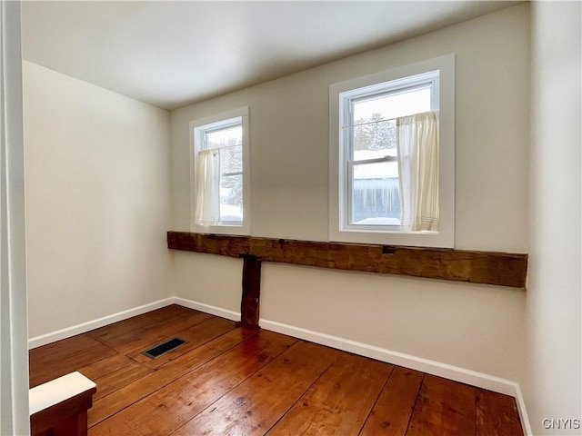 spare room with wood-type flooring