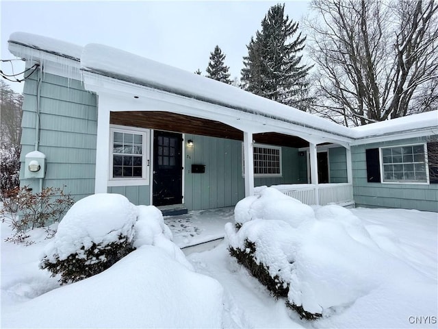 view of snow covered property entrance