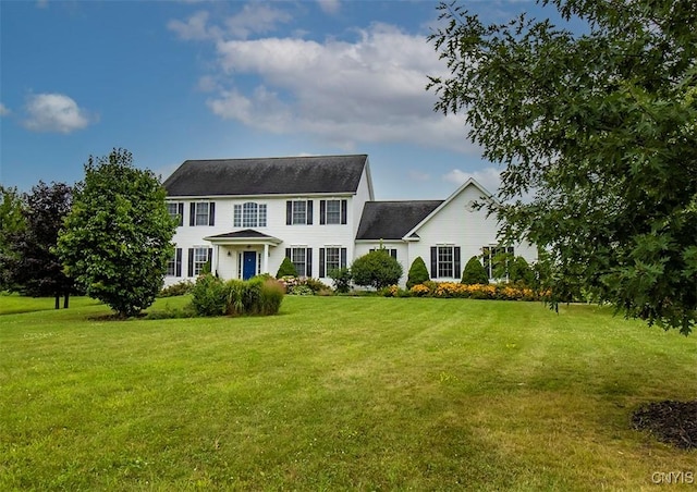 colonial inspired home featuring a front lawn