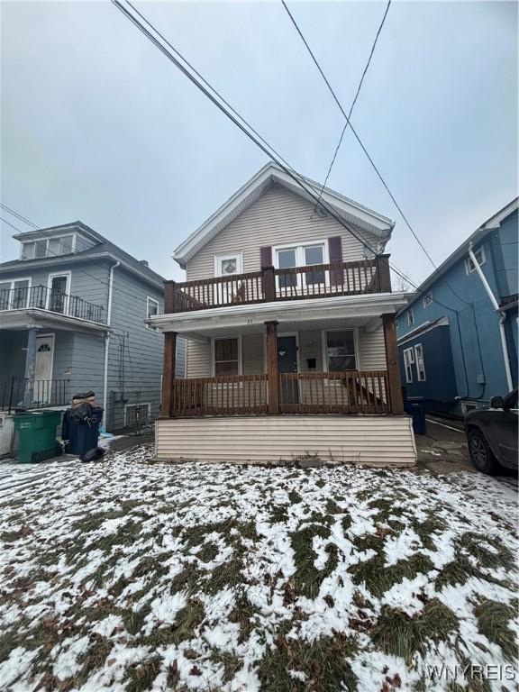 view of front facade featuring a balcony and covered porch