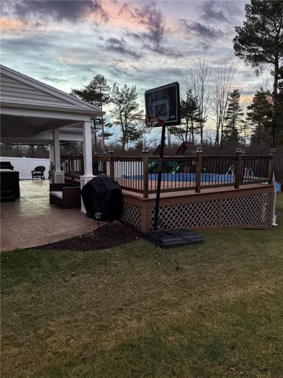 exterior space featuring area for grilling, a patio area, and a lawn