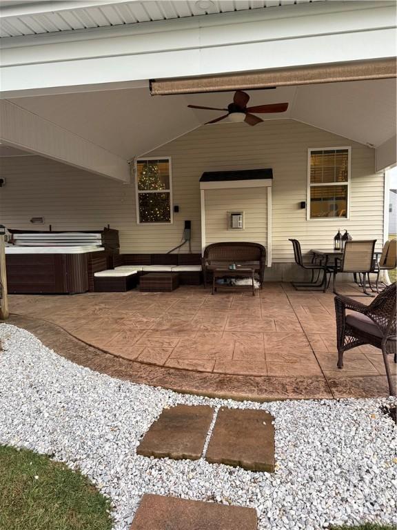 view of patio with a hot tub and ceiling fan