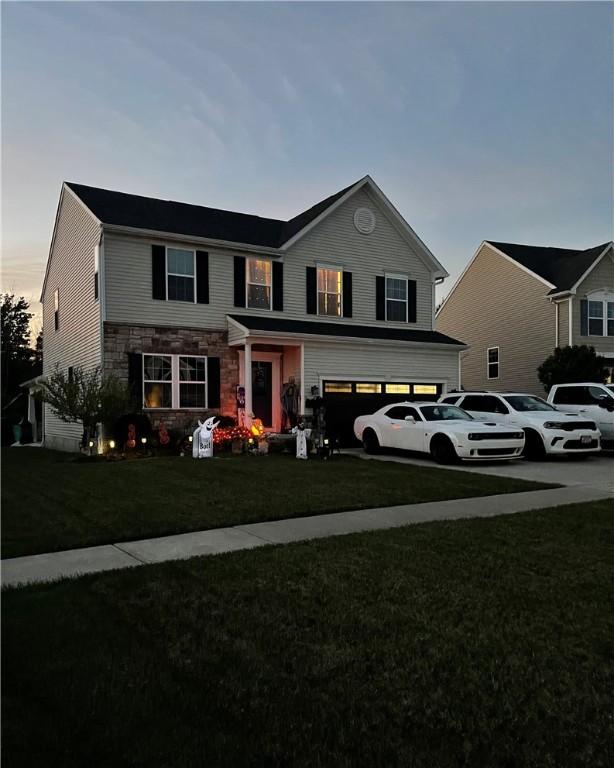 view of front property with a lawn and a garage