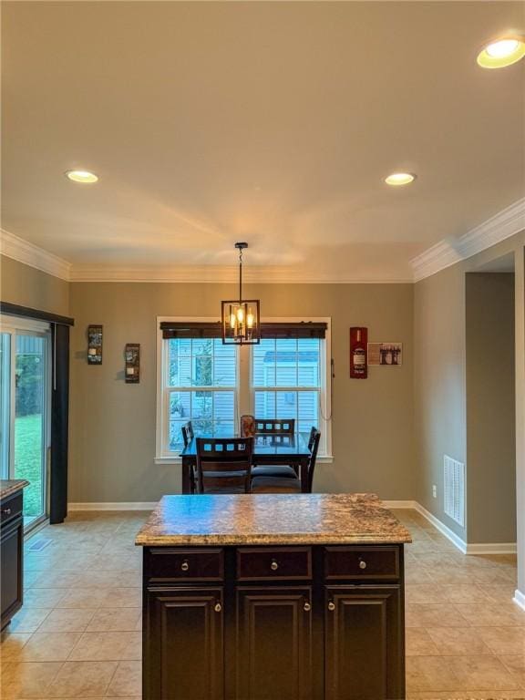 kitchen with ornamental molding, dark brown cabinetry, decorative light fixtures, a chandelier, and plenty of natural light