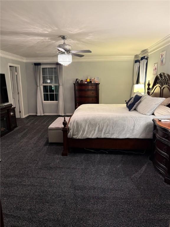 bedroom featuring carpet flooring, ceiling fan, and crown molding