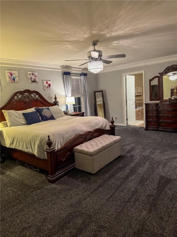 bedroom with carpet flooring, connected bathroom, ceiling fan, and crown molding