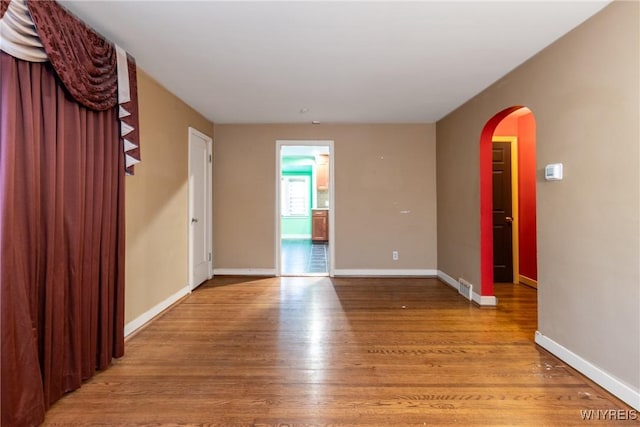 unfurnished room with light wood-type flooring