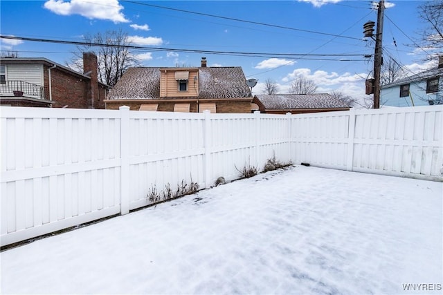 view of yard layered in snow