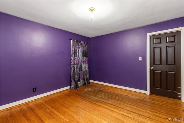 empty room with hardwood / wood-style floors