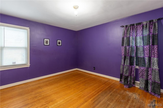 unfurnished room featuring hardwood / wood-style floors