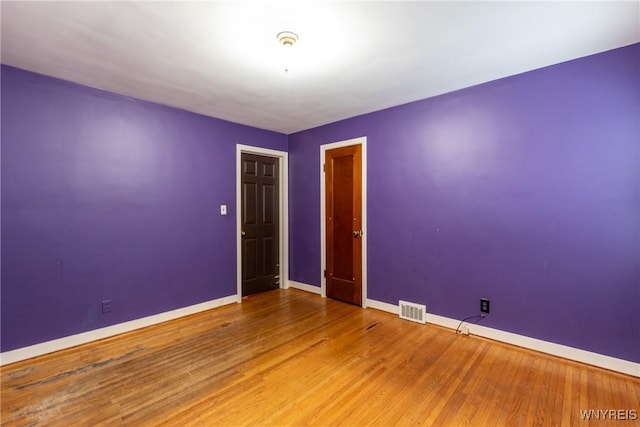 unfurnished room featuring wood-type flooring