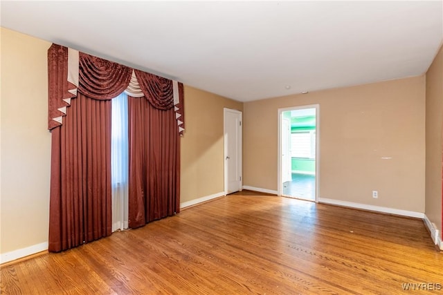 unfurnished room with wood-type flooring