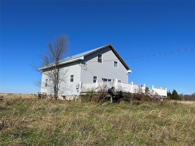 rear view of house featuring a deck