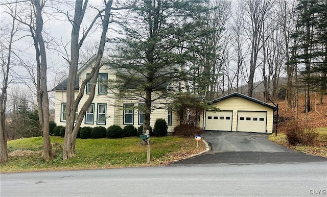 view of front of home with a front yard and a garage