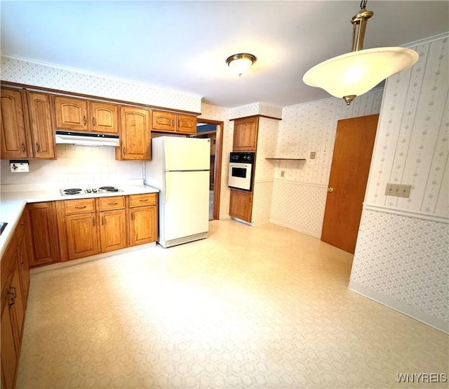 kitchen featuring hanging light fixtures, white appliances, and ornamental molding