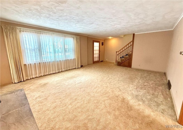 unfurnished living room with carpet and a textured ceiling