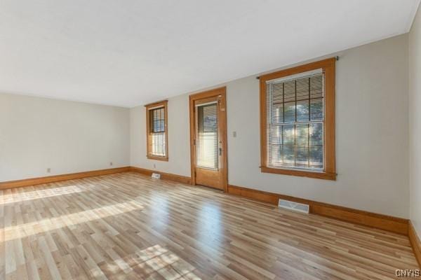 spare room with light hardwood / wood-style floors