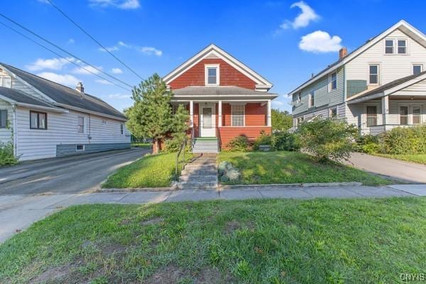 view of front of property with covered porch and a front lawn