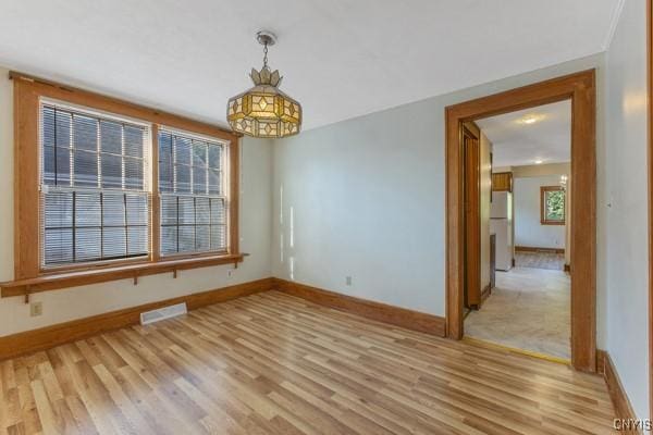 unfurnished room with light wood-type flooring