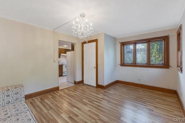 unfurnished bedroom with a notable chandelier and light hardwood / wood-style floors