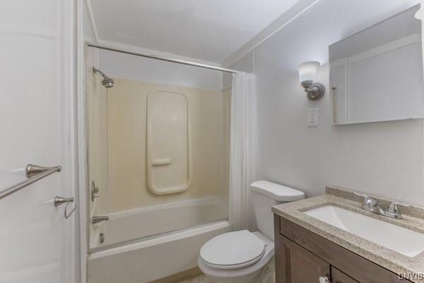 full bathroom with shower / tub combo, vanity, toilet, and crown molding