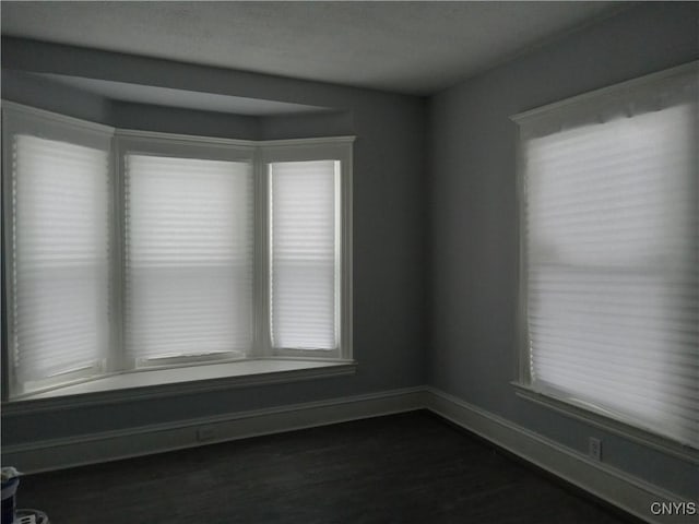 empty room with dark hardwood / wood-style floors