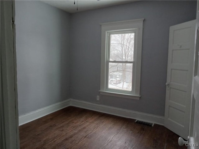 unfurnished room featuring dark hardwood / wood-style floors