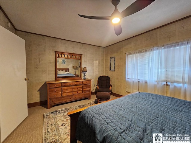 carpeted bedroom featuring ceiling fan and crown molding