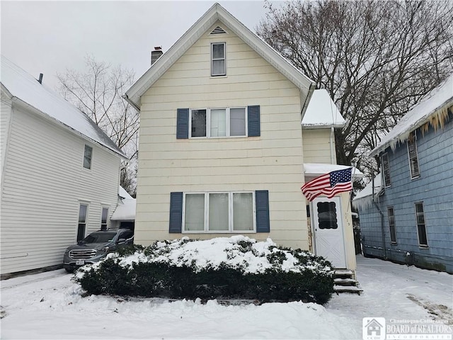 view of snow covered back of property