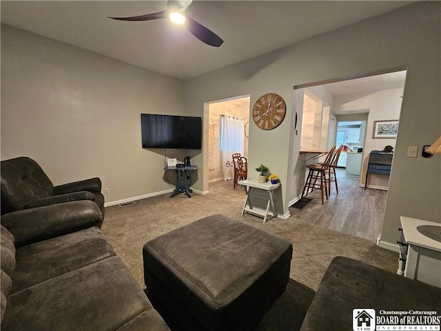 carpeted living room featuring ceiling fan