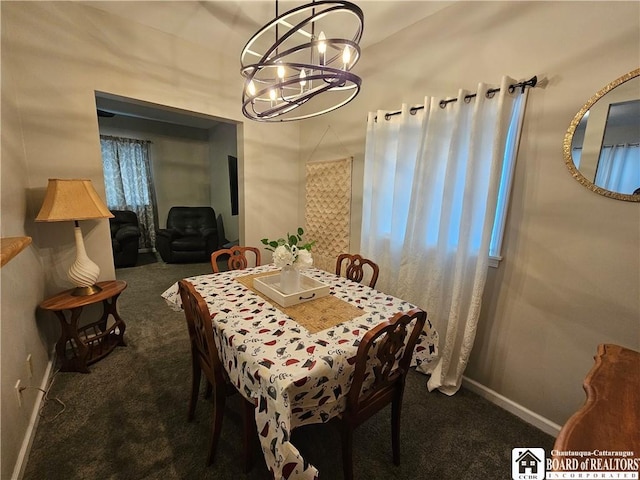 carpeted dining space featuring a chandelier