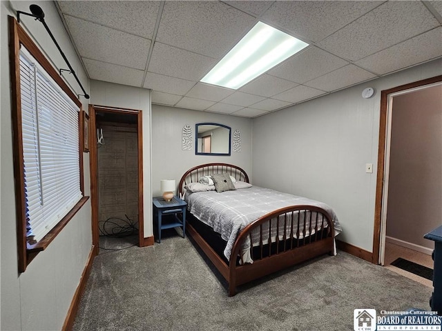 carpeted bedroom with a paneled ceiling