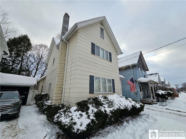 snow covered property featuring a garage