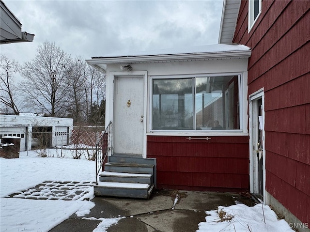 view of snow covered property entrance