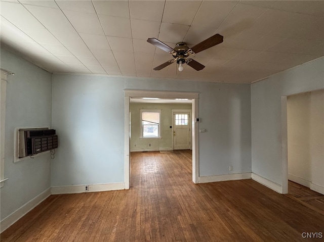 unfurnished room with hardwood / wood-style floors, ceiling fan, and an AC wall unit