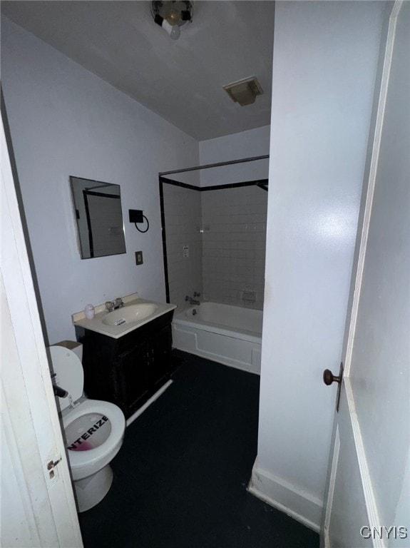 full bathroom featuring vanity, tiled shower / bath combo, and toilet